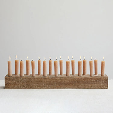 Long wood candle taper holder with 17 burning candles.