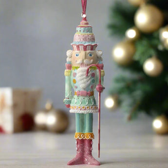 6 inch hand painted nutcracker ornament in a candy theme. 