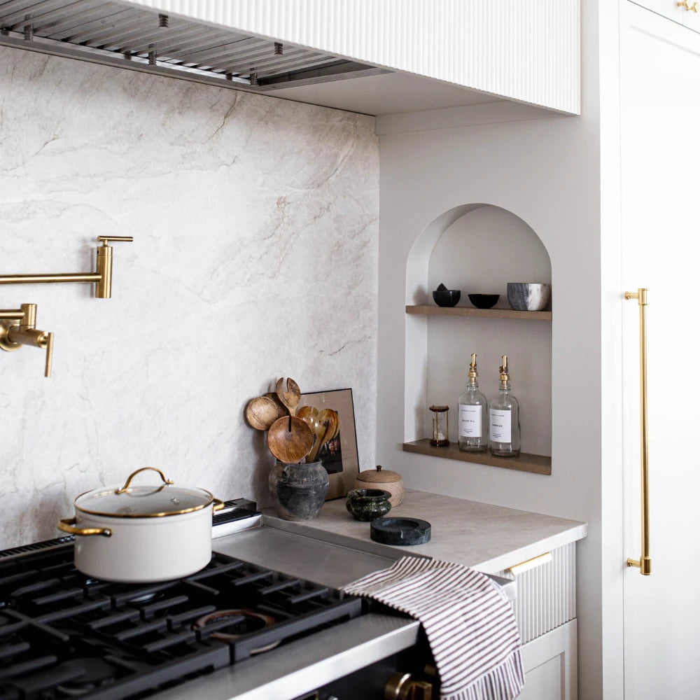 Cotton brown and white striped ruffle towel styled in an all white kitchen with gold accents.