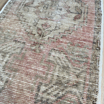 Pale pink, beige and light brown are the main colours in this Turkish are rug. 