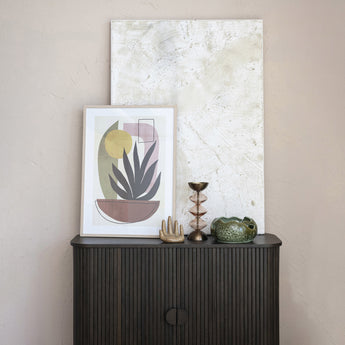 Stoneware Organic Shaped Bowl displayed on top of a wood cabinet with artwork.