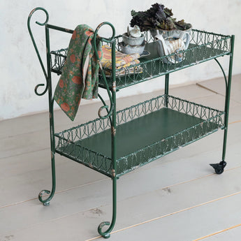 Vintage inspired Metal Two-Tier Bar Cart with tea towels, pots and planters. 