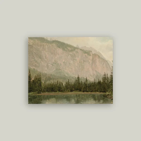 Mountain Pine Artist Board featuring soft pink hues of a mountain side and lush green trees surrounding a lake. 