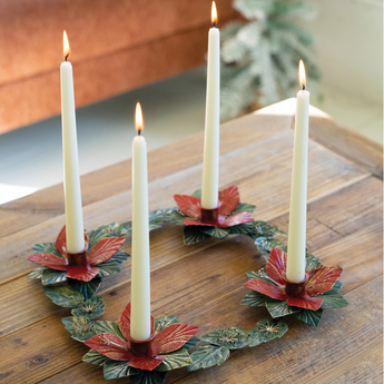 Poinsettia Table Wreath as a centerpiece on a rustic coffee table with 4 taper candles burning. 