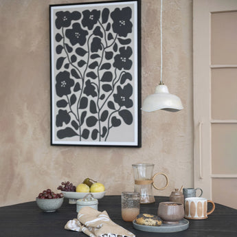 Simple stoneware off-white pendant lamp over a dining table. 