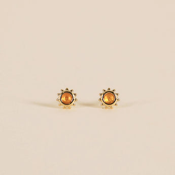 Gold plated sun studs with an amber stone in the center. 