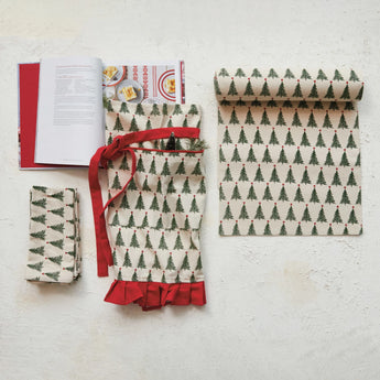 Various christmas tree themed items styled with a cookbook. 