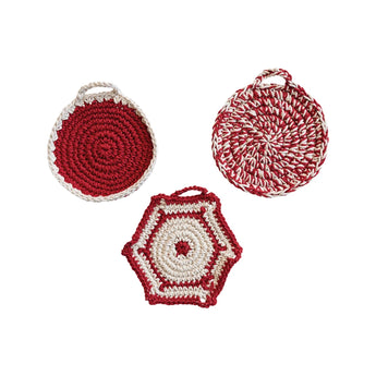 Three different styles of stylish red and white pot holders.