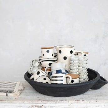 Decorative Vintage Reproduction Clay Dahi Bowl filled with various polka-dot designed dishes .