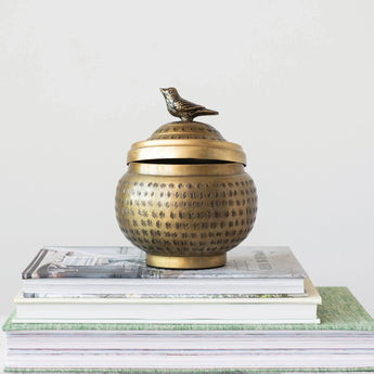 Decorative Hammered Metal Container with Lid & Bird Finial on stack of books 