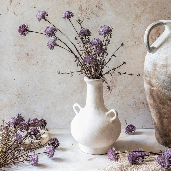Meadow flower melaleuca purple stems in a beautiful white vase. 