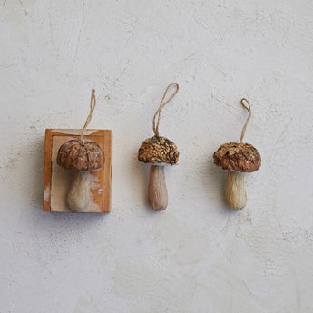 Wood Bark Mushroom Ornament with Glitter on a tabletop.