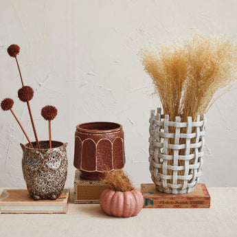 Stoneware Owl Shaped Planter with Reactive Glaze styled with thistles and other planters. 