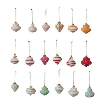 Assorted colors of paper mache ornaments .