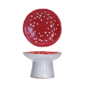 A quaint footed dish shaped like a mushroom, featuring a reactive glaze in vibrant red and white.