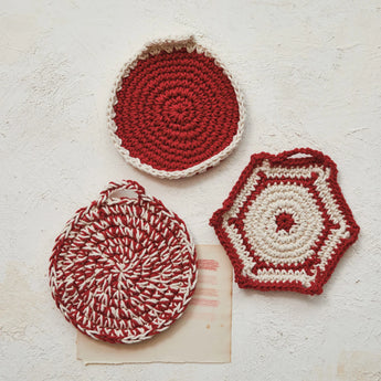 Three different styles of stylish red and white pot holders.