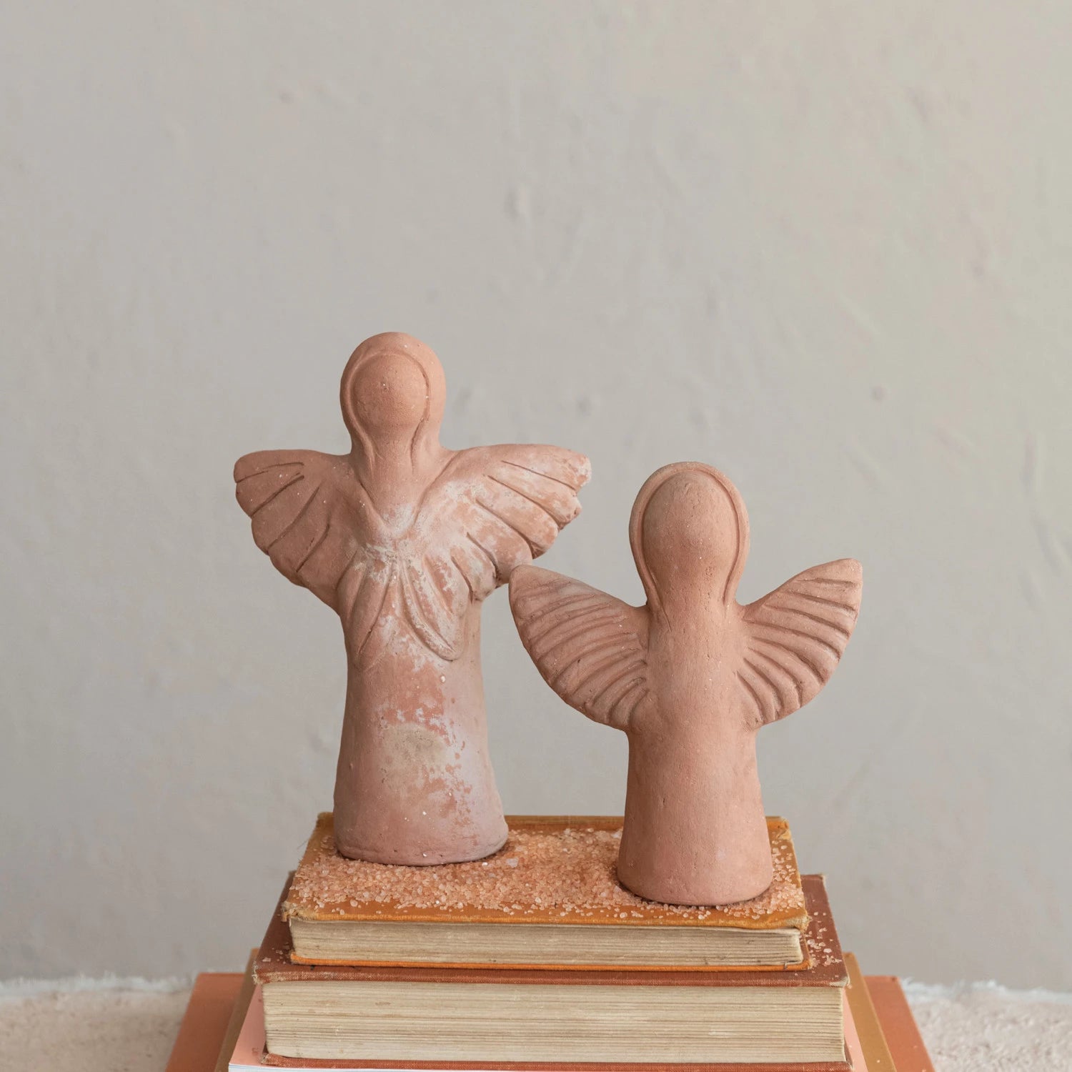 Two sizes of handmade terracotta angels.