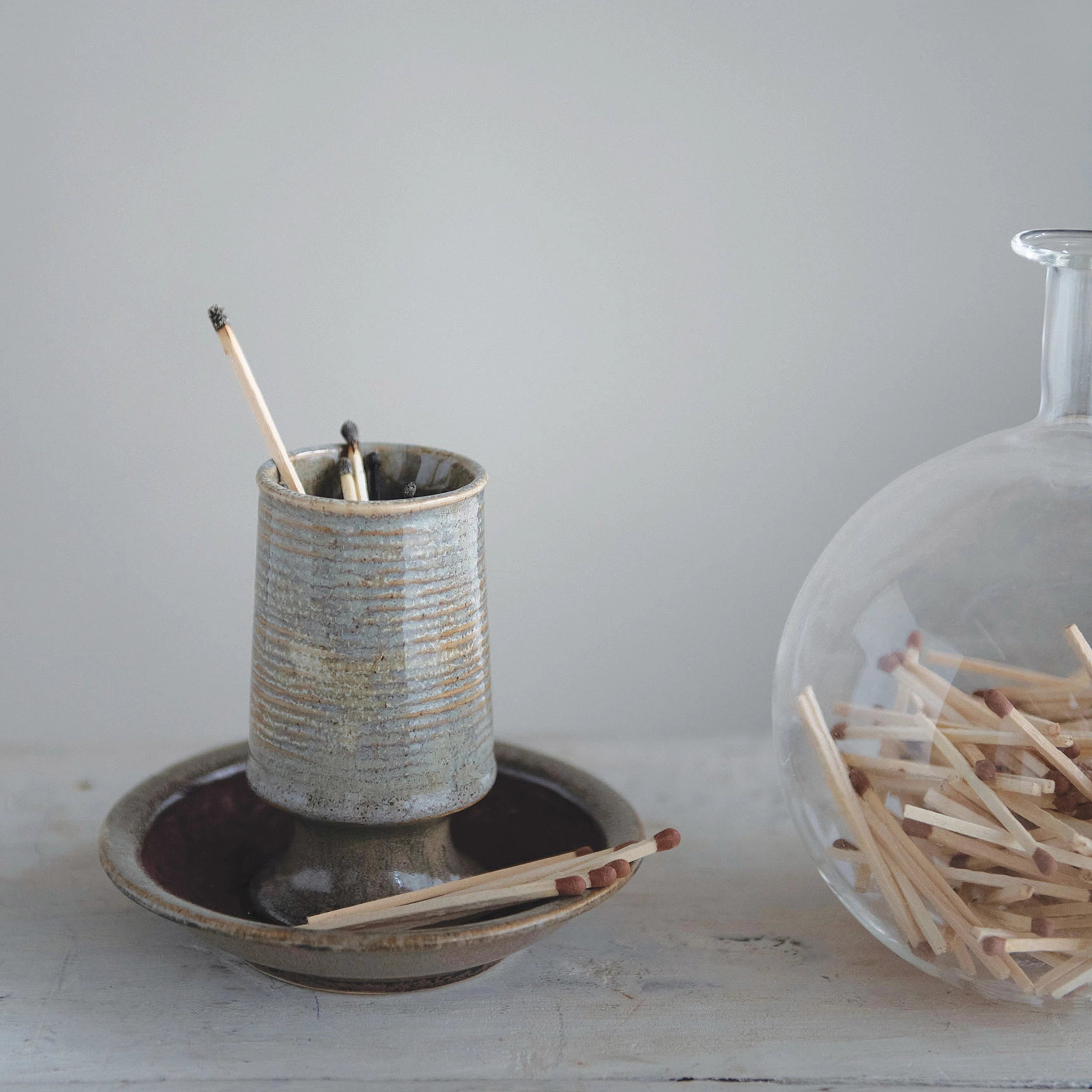 Stoneware Match Holder with Striker Plate displayed with wooden matches. 